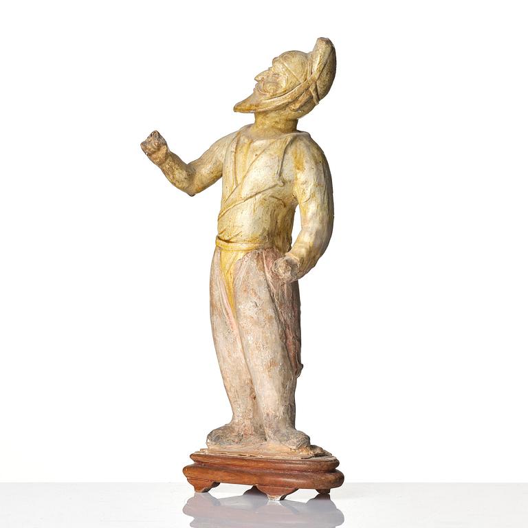 A yellow glazed potted figure of a groom, Tang dynasty (618-907).
