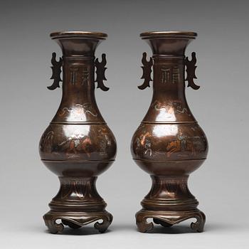 A pair of bronze vases with copper and silver inlay, Qing dynasty (1664-1912).