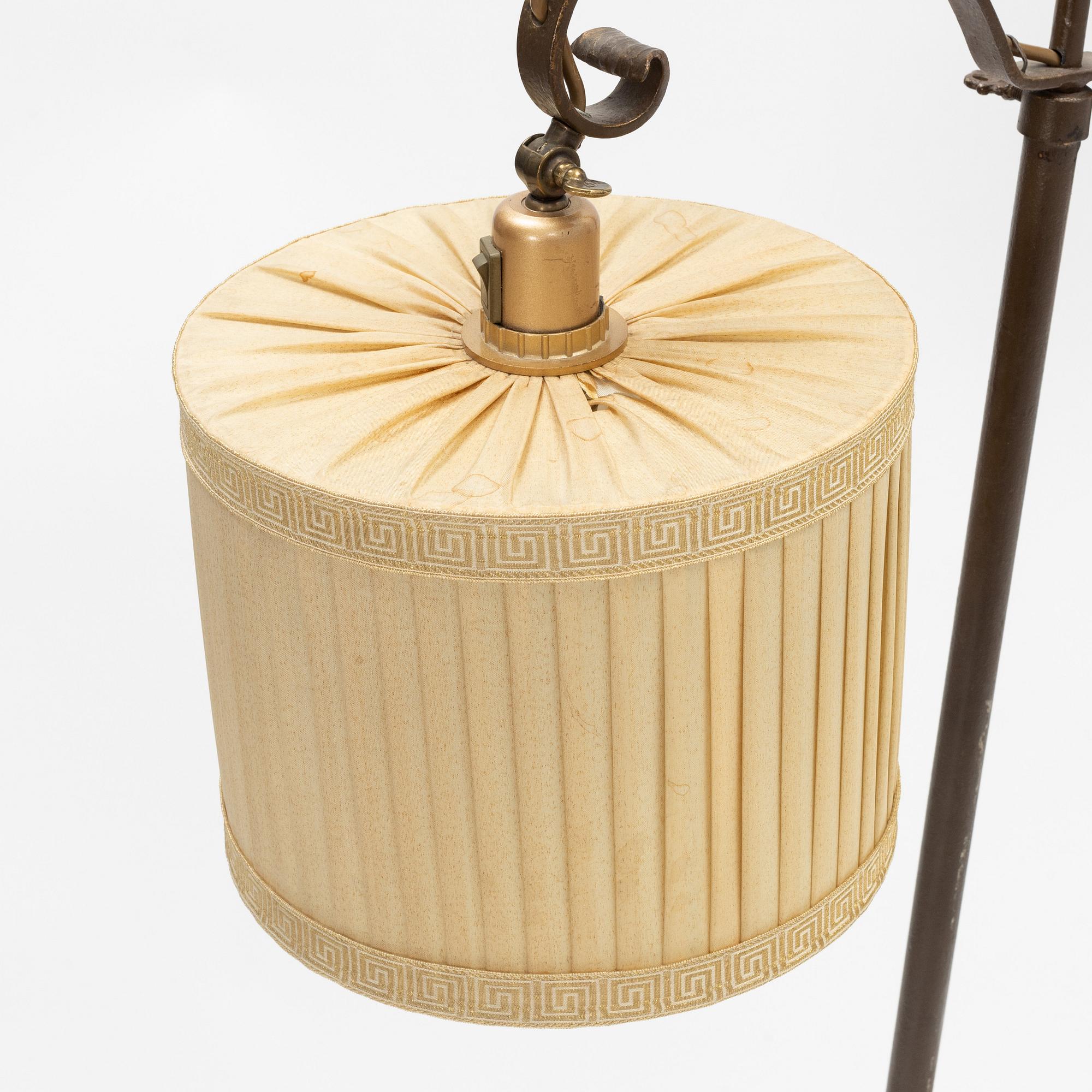 An iron floor lamp, early 20th Century.