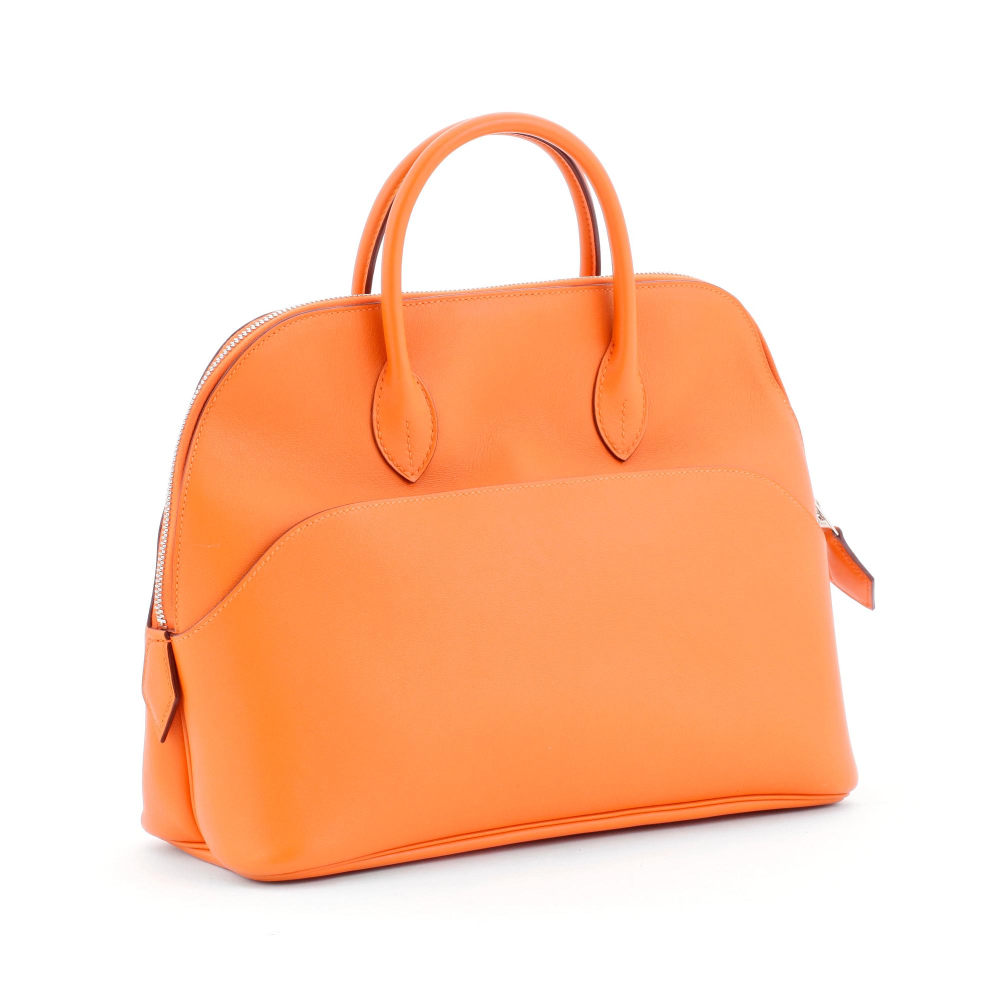 HERMÈS, a orange calf leather handbag, "Bolide".
