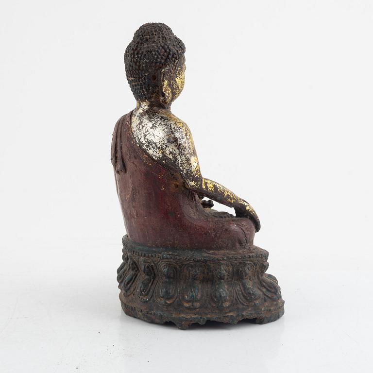 A Chinese cast iron figure of a Buddha, probably late Ming dynasty.