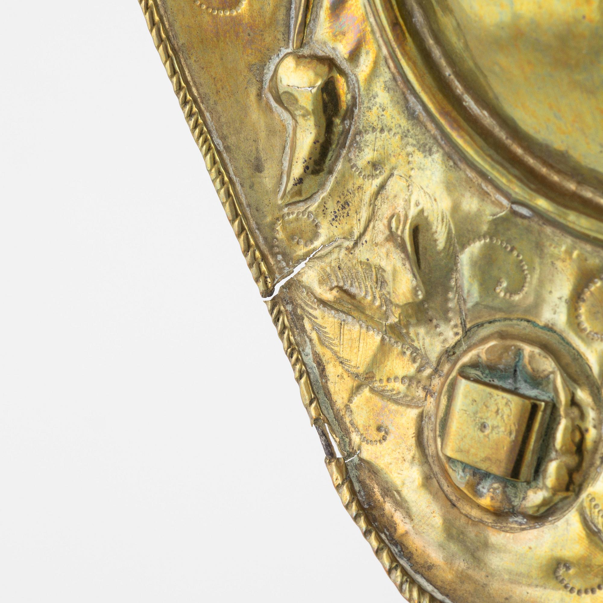 A pair of Baroque repoussé brass one-light sconces, first part of the 18th Century.