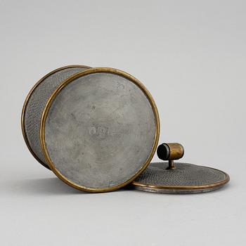 a pewter and brass jar with cover by Svenskt Tenn, Stockholm 1936.