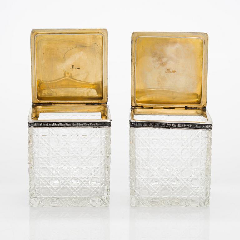 K. Fabergé, a pair of cut-glass toilette boxes in silver stand, Imperial Warrant mark, Moscow 1896.