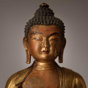 A finely cast Tibeto-Chinese gilt bronze figure of Shakyamuni Buddha, Qing dynasty, circa 1800.