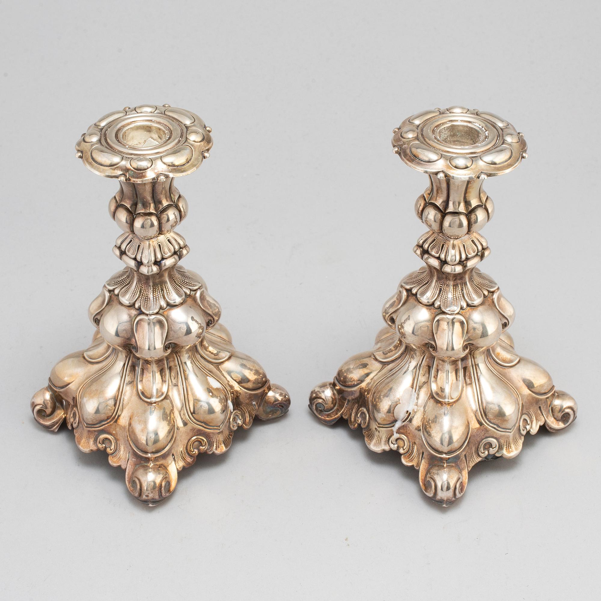 A pair of silver candle sticks.-.