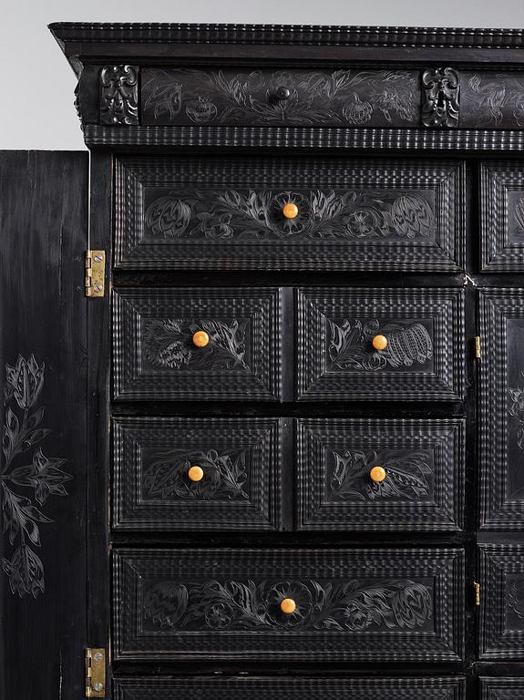 A Louis XIV and Louis XIV-style carved ebony, ivory and tortoiseshell-inlaid cabinet on stand, 17th and 19th century.