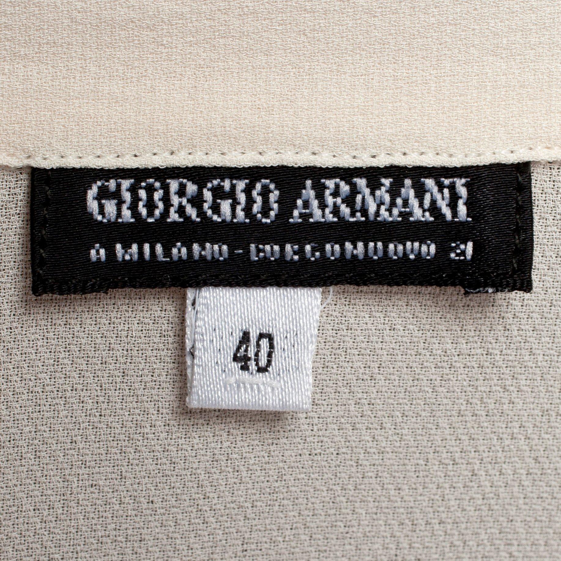 GIORGIO ARMANI, a light beige silk blouse.