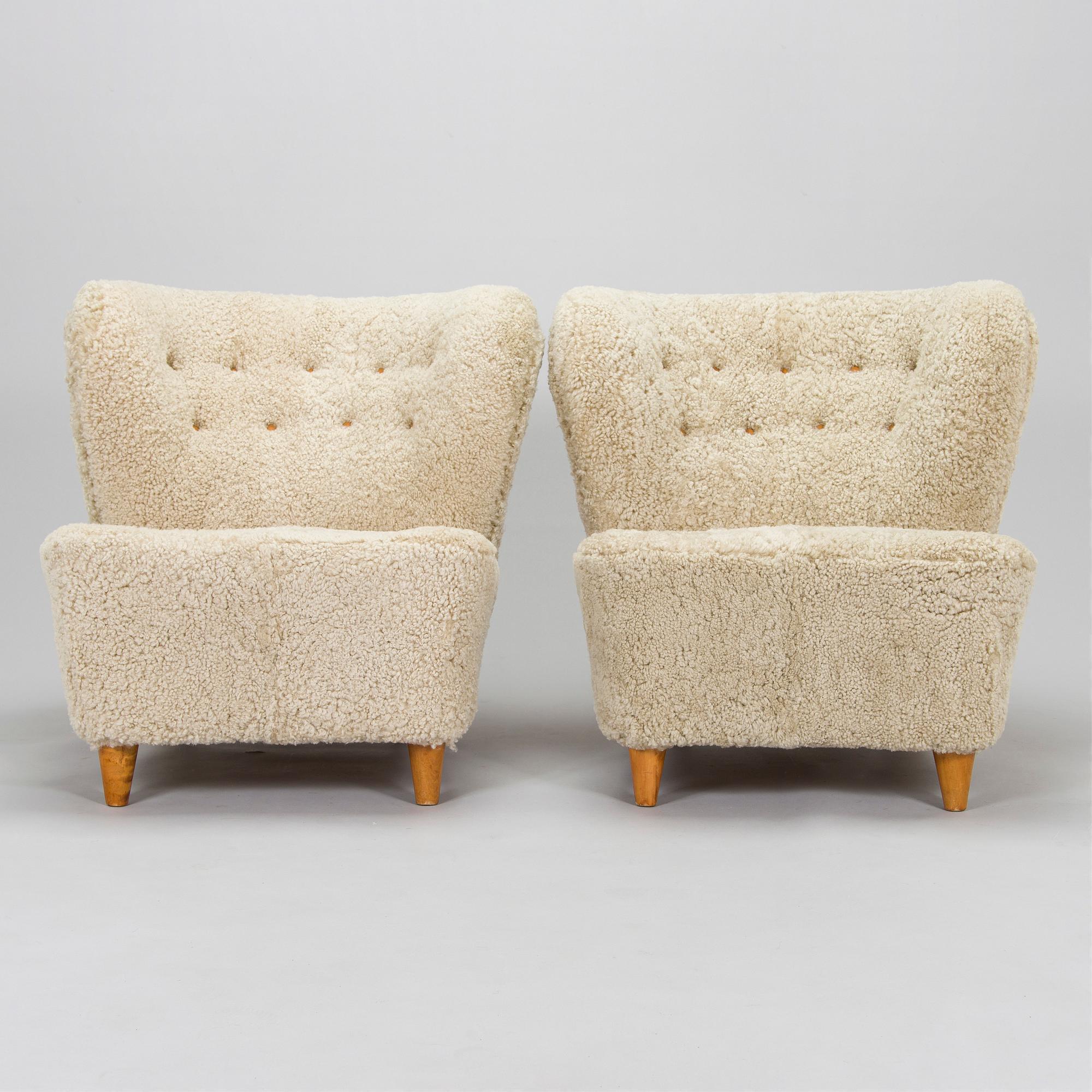 A pair of mid-20th century armchairs in sheepskin.