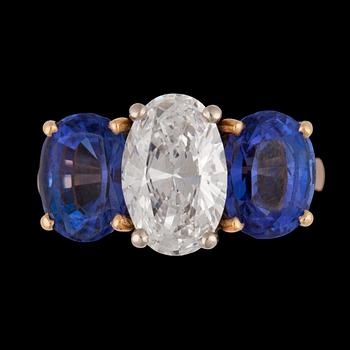 1358. An oval brilliant cut diamond, app. 2.10 cts and tanzanite ring.