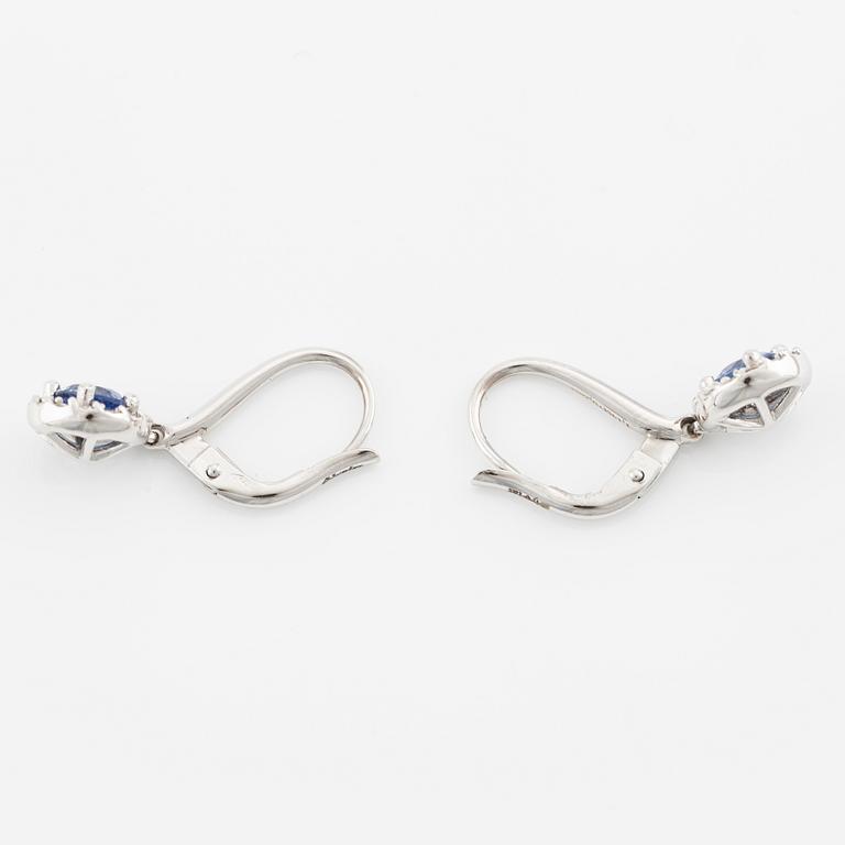 A pair of 18K gold earrings with faceted sapphires and round brilliant-cut diamonds.