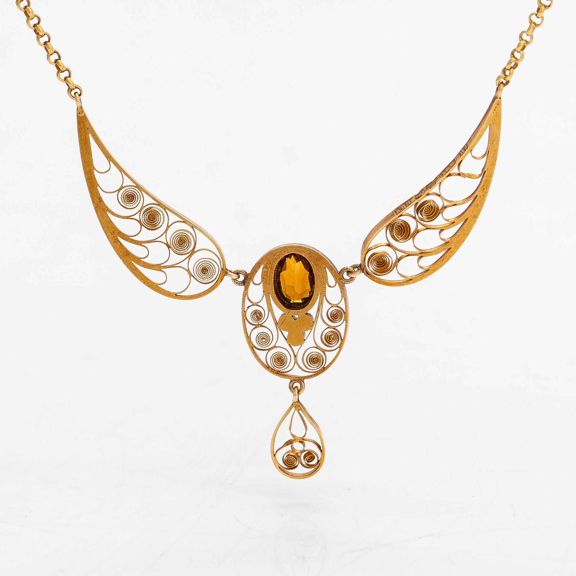 An 18K gold filigree necklace with seed pearls and a citrine, Stockholm 1910.