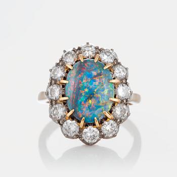 961. An opal ring with round brilliant-cut diamonds with a total weight of ca 1.20 cts.