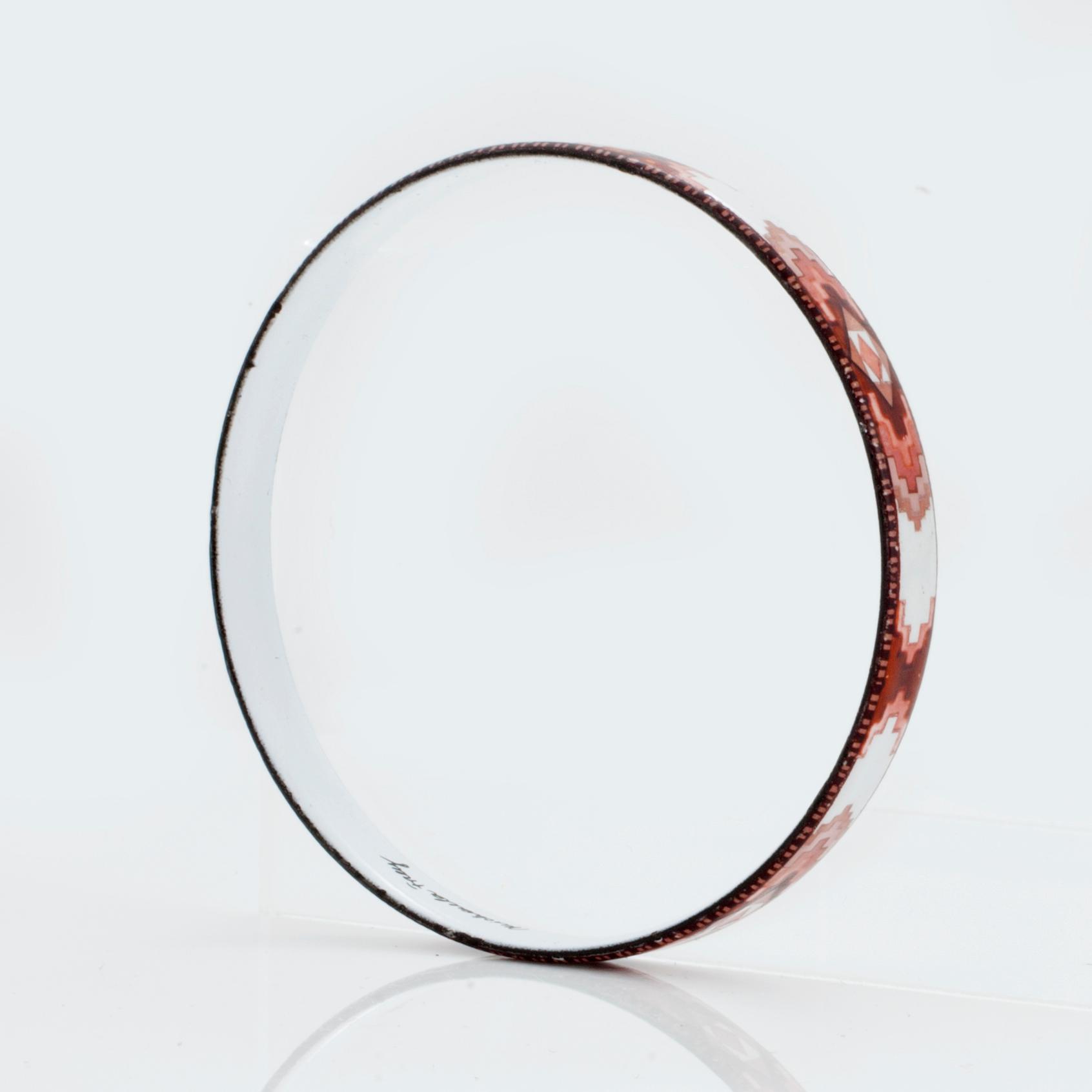 A bangle by Michaela Frey with multi-coloured enamel decoration.