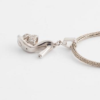 18K white gold shoe pendant with faceted white stones, silver chain.