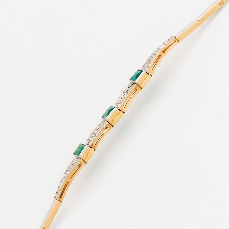 An 18K gold and platinum bracelet set with step-cut emeralds and old- and eight-cut diamonds.