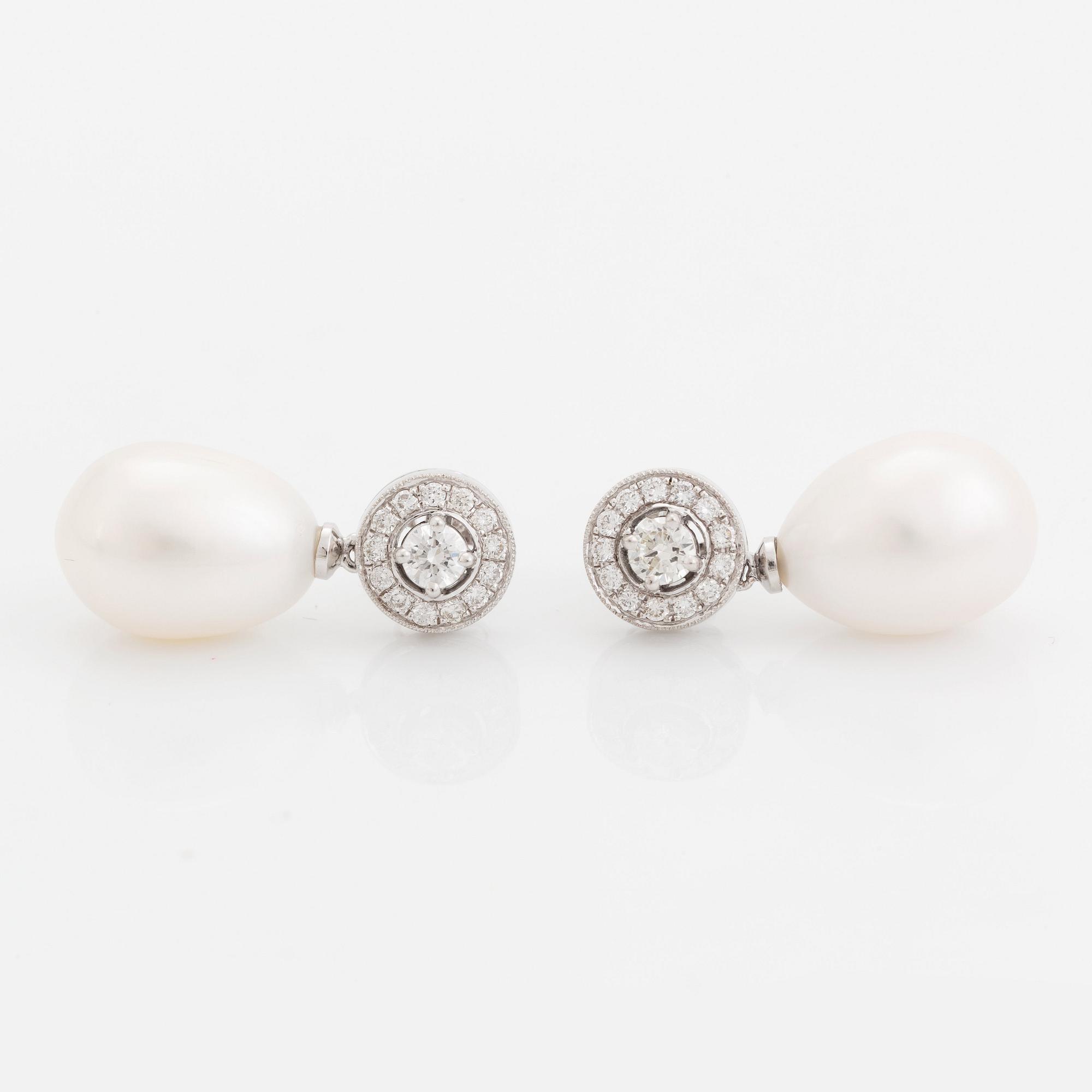 A pair of 18K white gold and cultured pearls earrings set with round brilliant-cut diamonds.