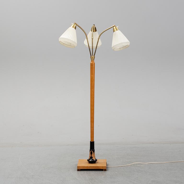 An elm floor light, mid 20th Century.