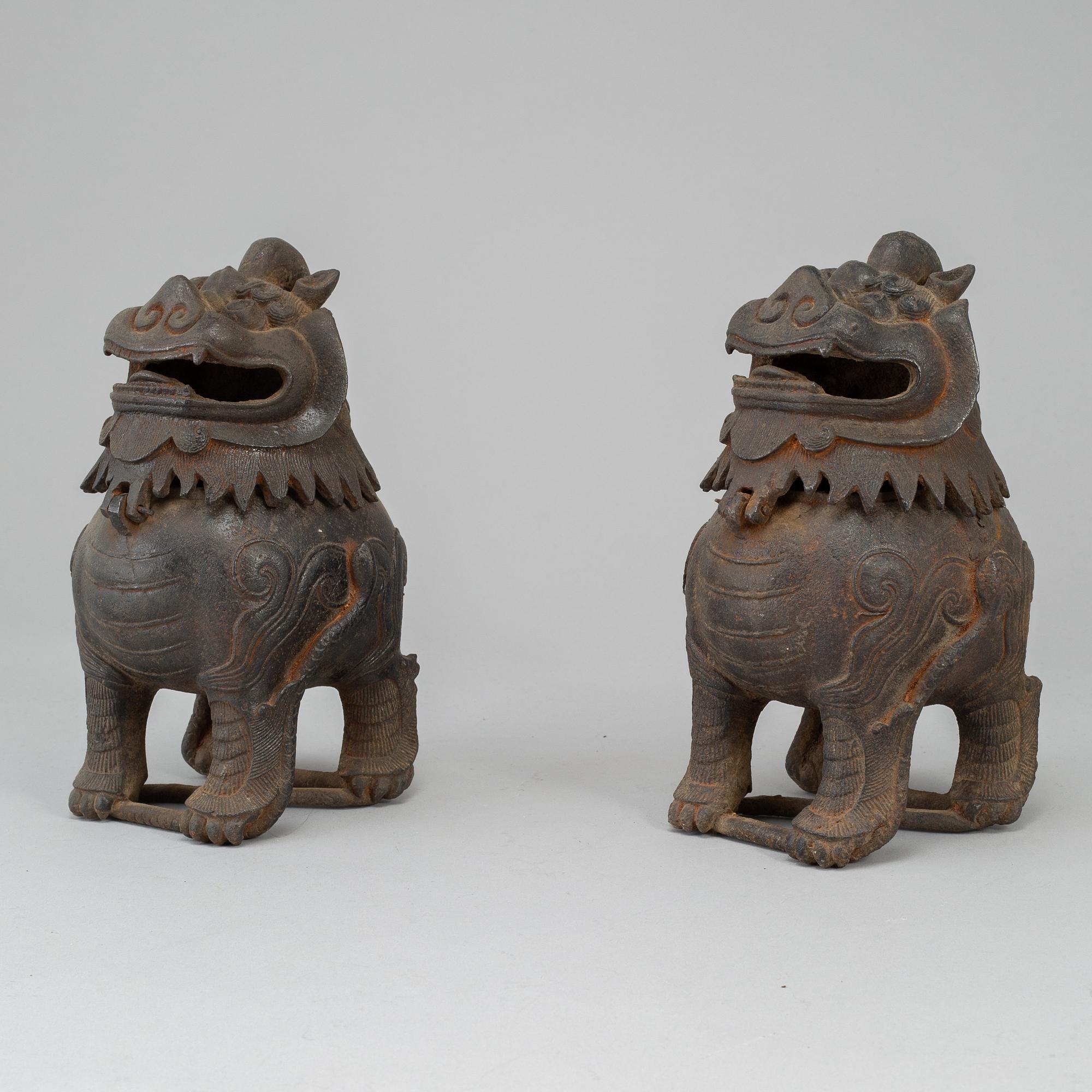 A pair of Chinese iron Fo dogs, 20th Century.