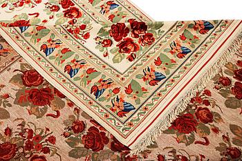 A carpet with a rose pattern, c. 310 x 196 cm.