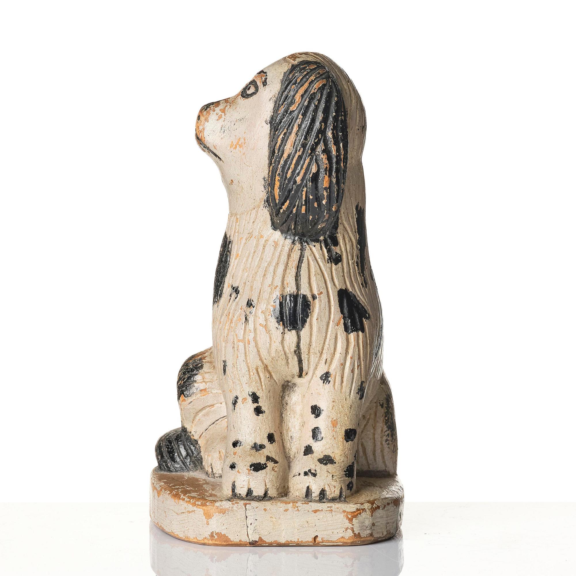 A Swedish wooden folk-art sculpture depicting a 'Staffordshire dog' ceramic figurine, 19th century.