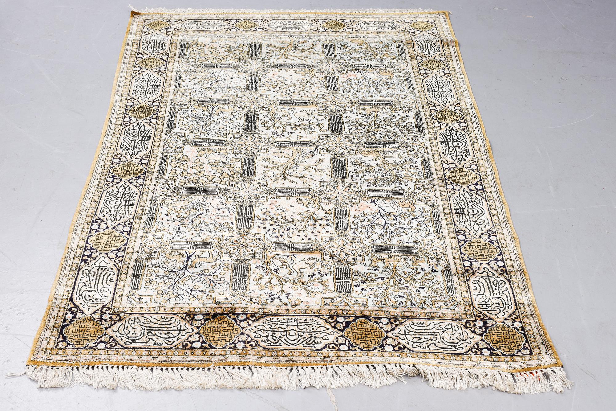 A rug, Old silk Qum, figural,  ca 214 x 142 cm.