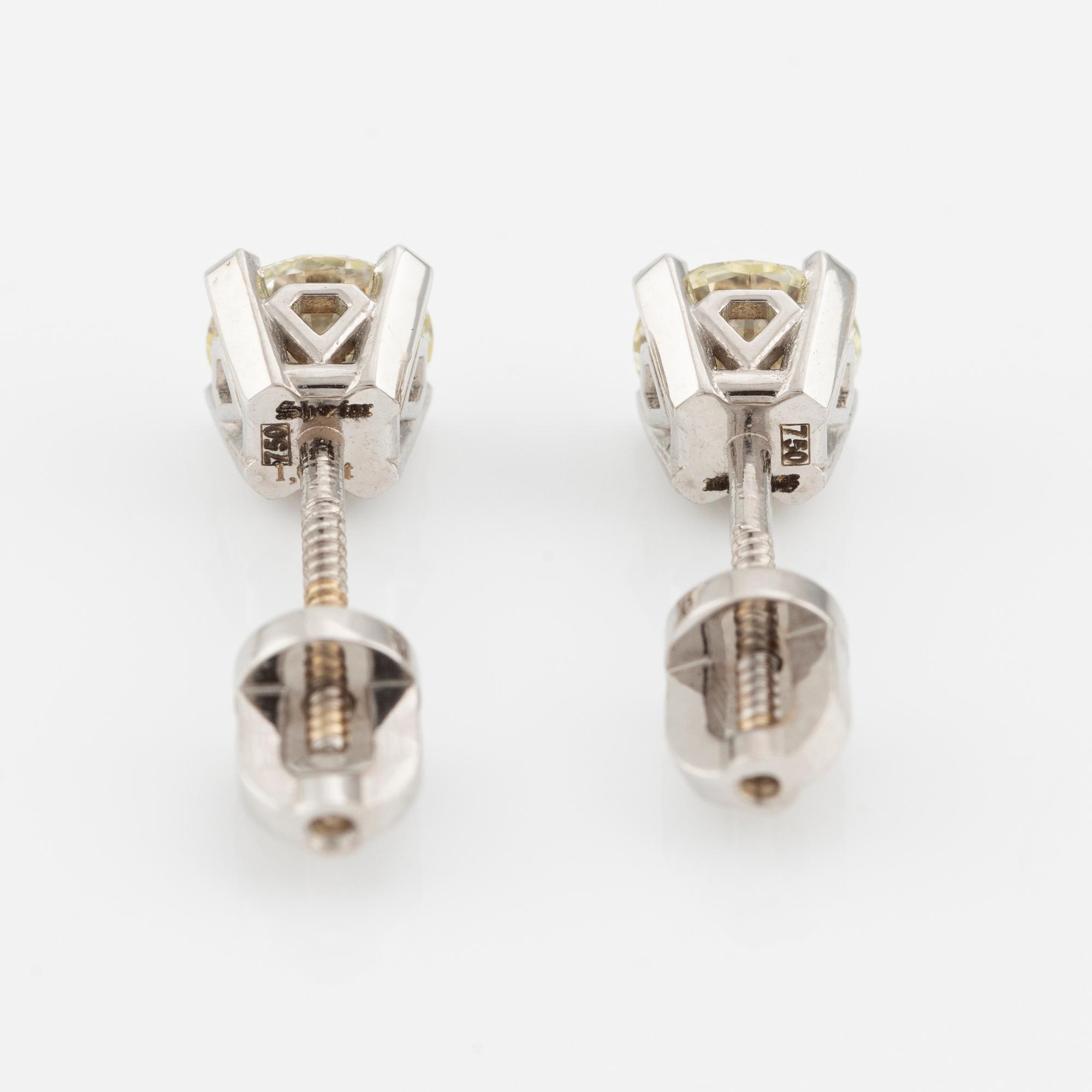A pair of 18K gold earrings with round brilliant-cut diamonds.