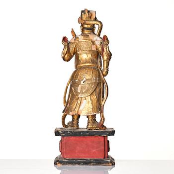 A gilt and lacquered standing figure of a guardsman, Qing dynasty.