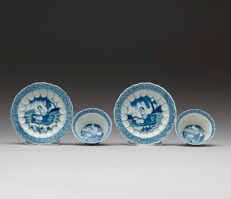 A pair of blue and white "erotic" cups with saucers, Qing dynasty Kangxi (1662-1722).