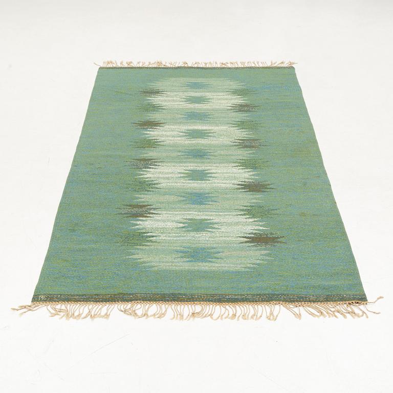 A flat weave rug, signed ML, c. 270 x 150 cm.