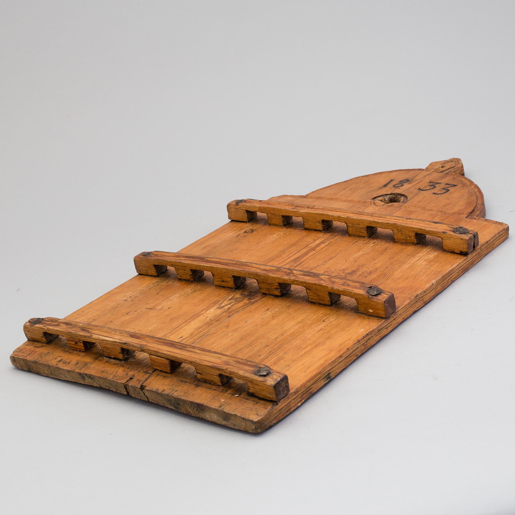 A folk art spoon shelf dated 1833.