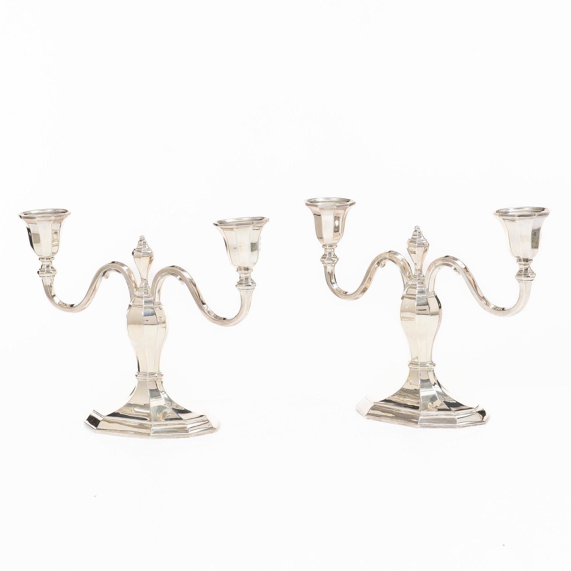 A pair of silver candelabras, with Swedish import marks, possibly mid20th century.