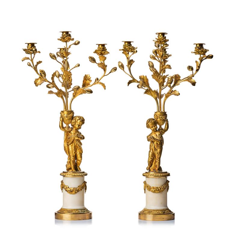 A pair of Louis XVI four light candelabra.