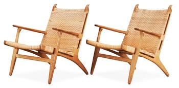 A pair of Hans J Wegner oak and rattan 'CH-27' armchairs, Carl Hansen & Son, Denmark, 1950's-60's.