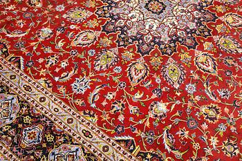 A Keshan carpet, part silk, signed, approx. 398 x 270 cm.
