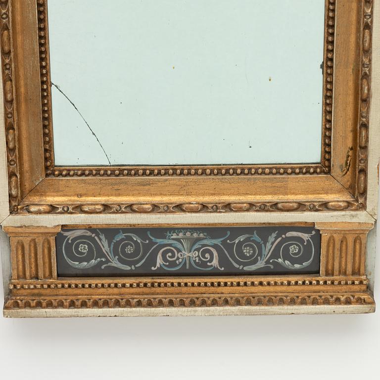 A late Gustavian giltwood and gouache-inset mirror, late 18th century.