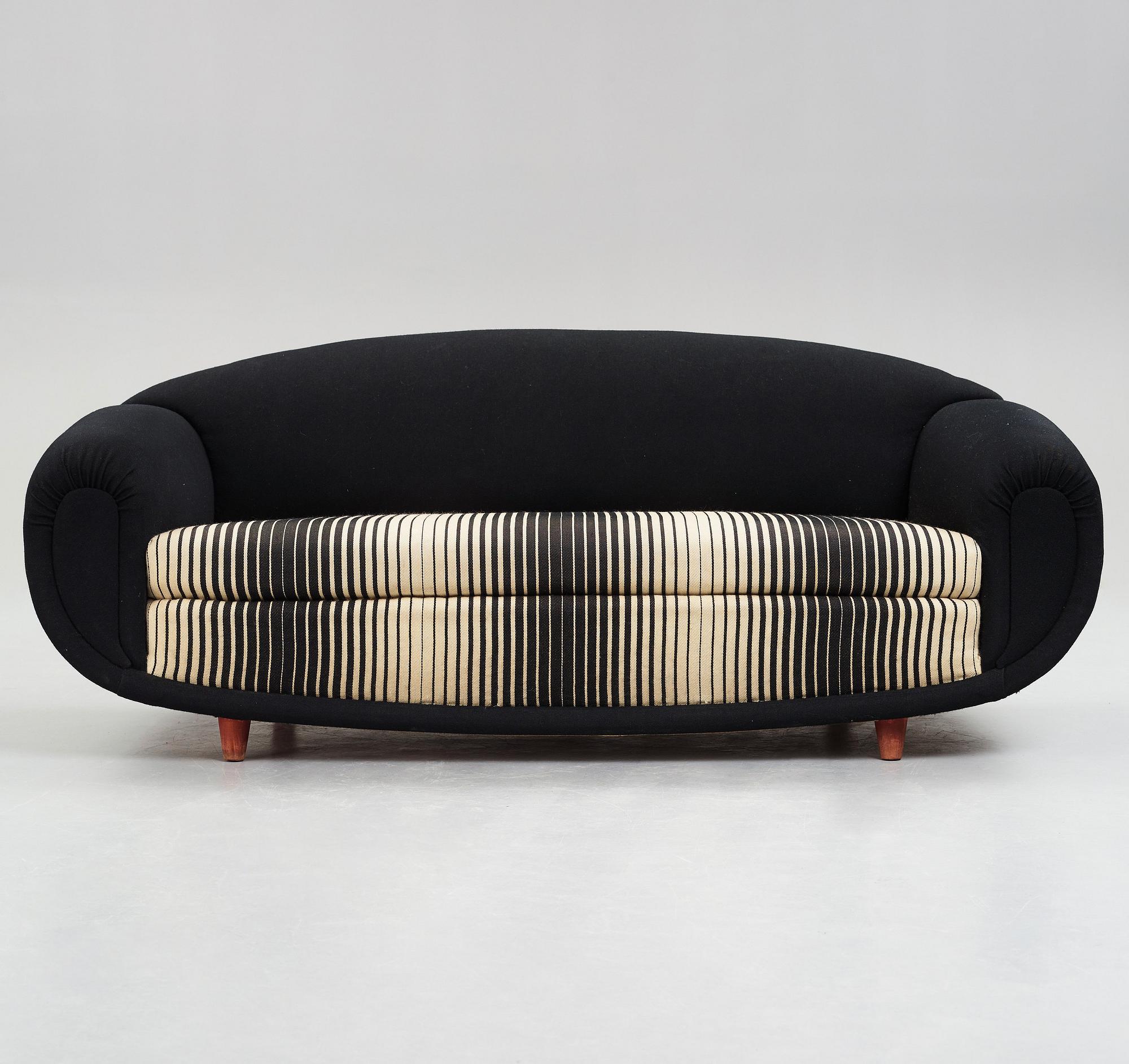 A 1940's sofa, upholstered in black and white striped fabric.