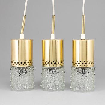 Three brass and glass pendant lights, 1960's.