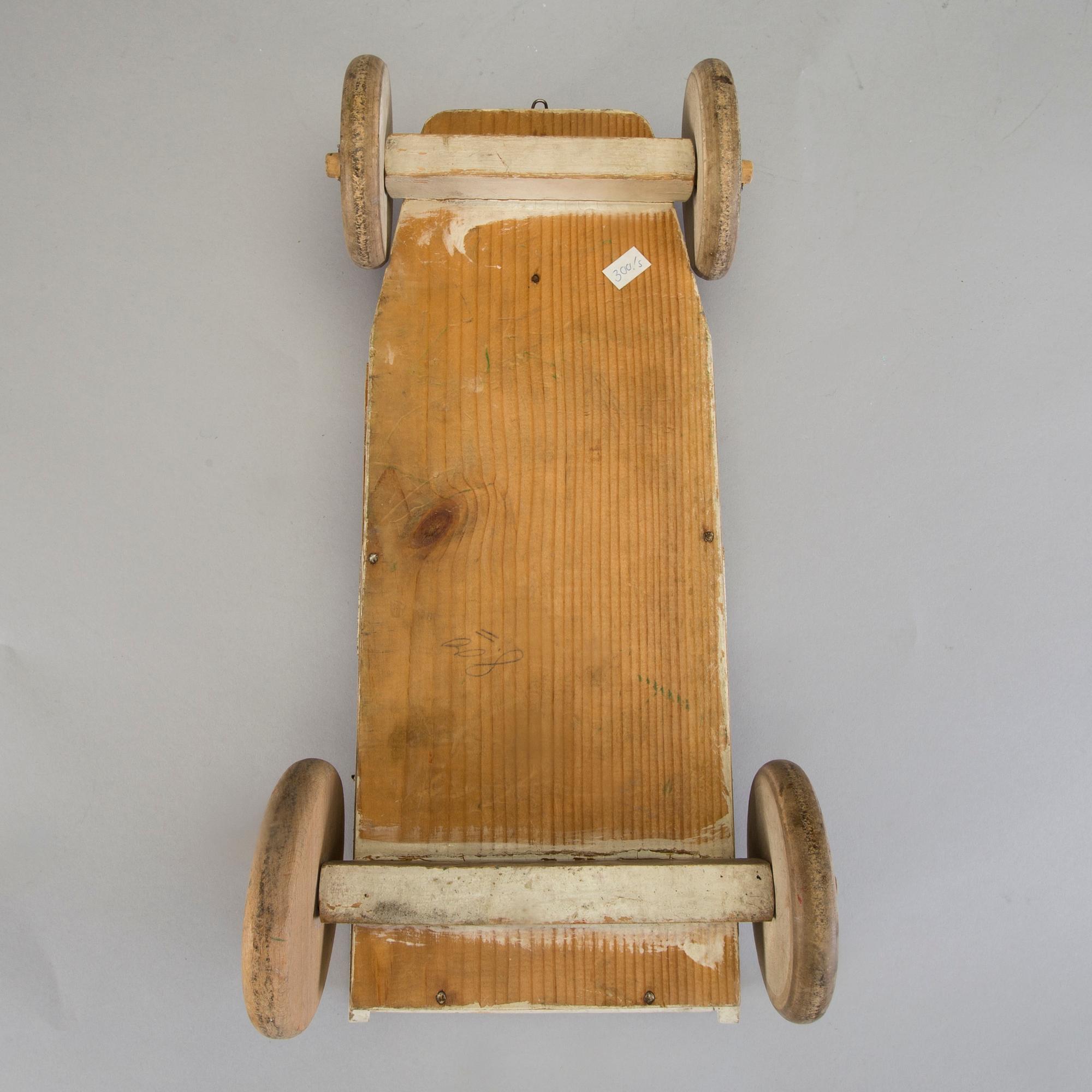 A painted wooden toy car c. 1910.