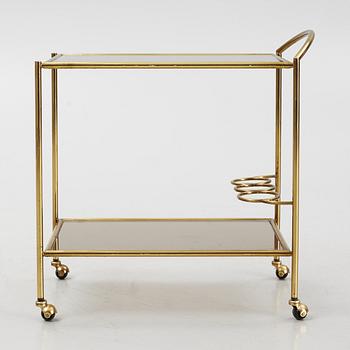 A 1970's glass and brass drinks trolley.