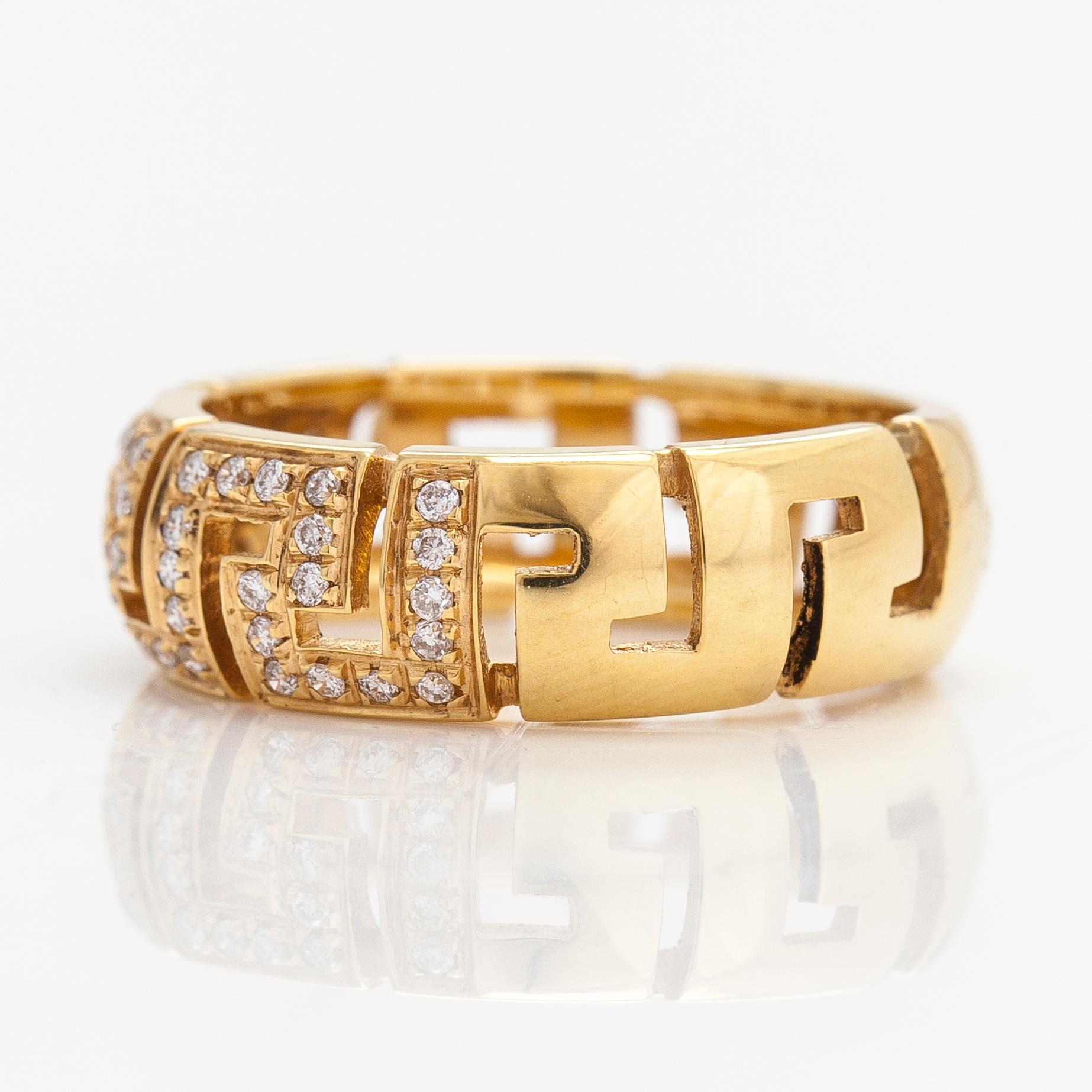 Versace, An 18K gold ring with diamonds ca. 0.12 ct in total. Marked Versace.