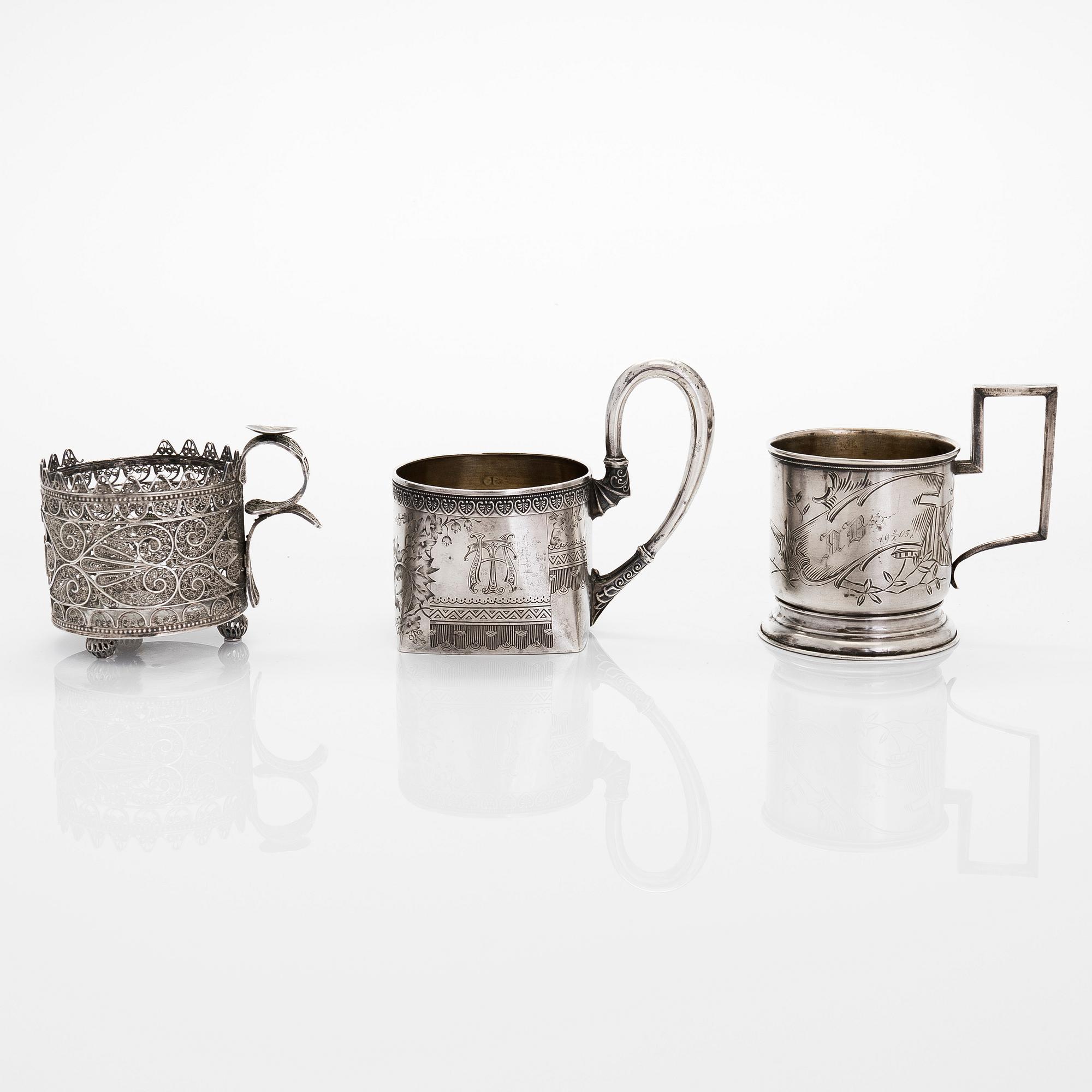 Three silver tea glass holders and four spoons, silver Kostroma and Moscow, late 19th and early 20th centuries.