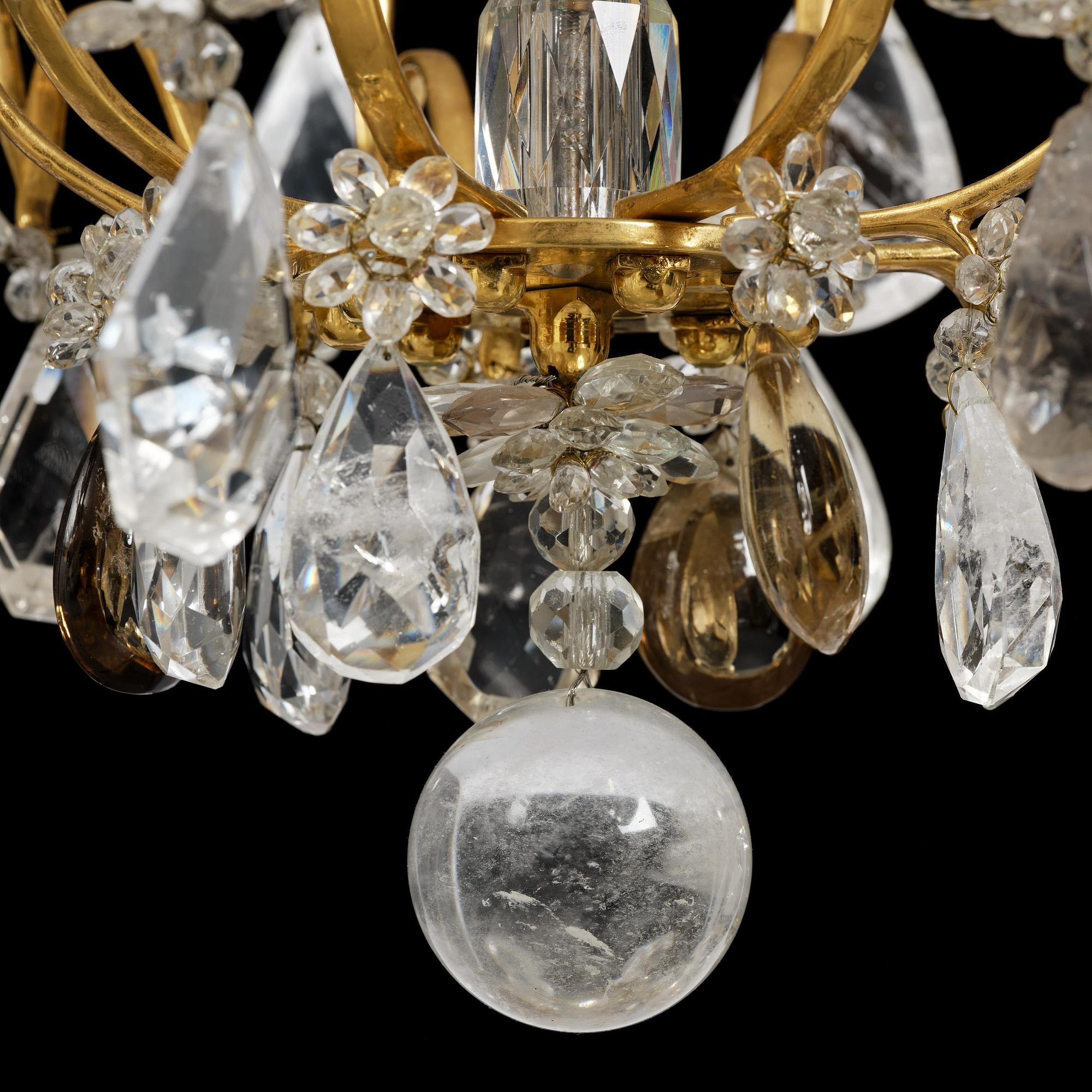 A near pair of Franch Louis-XV-style nine-branch gilt bronze and rock crystal chandeliers, later part 19th century.