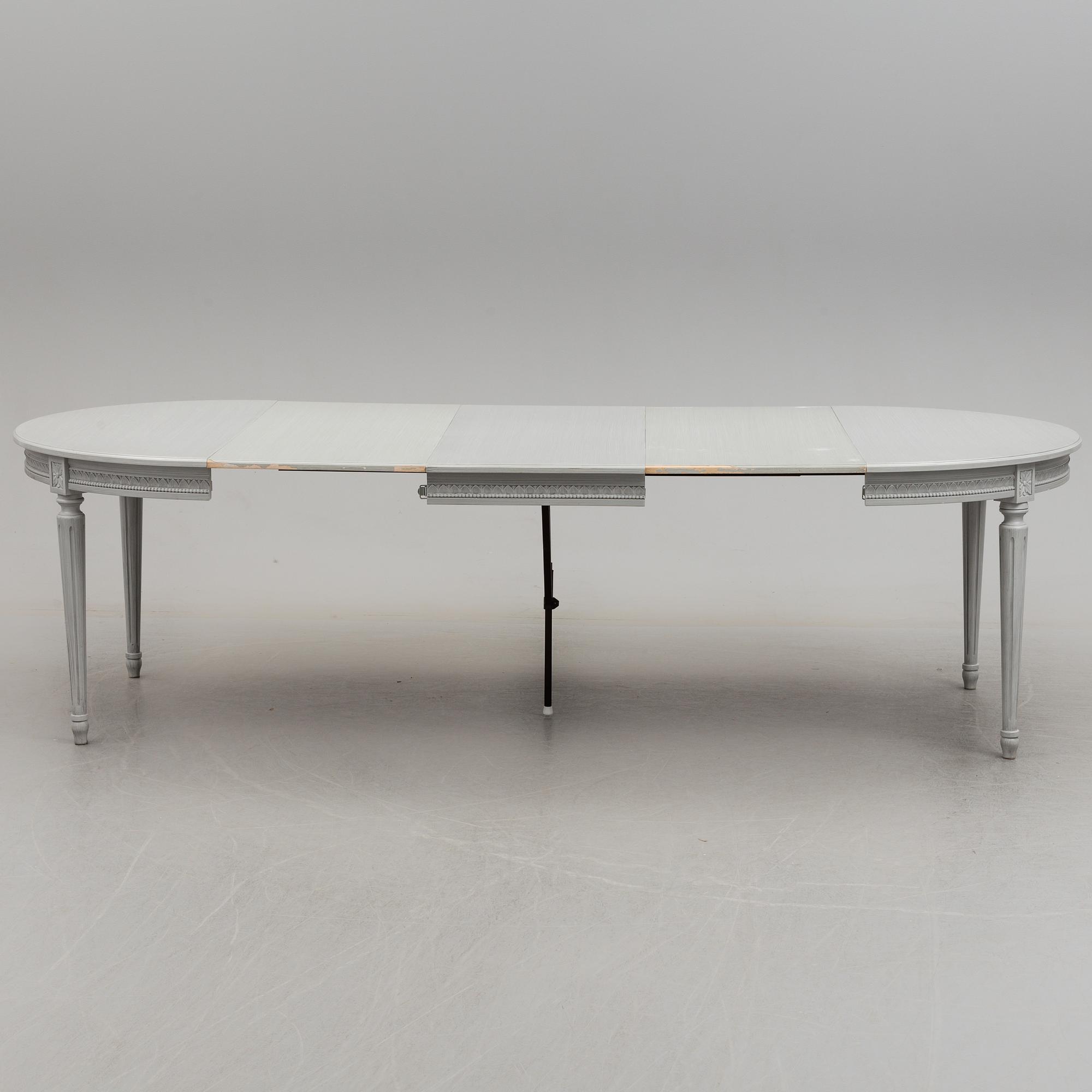 A Gustavian style dining table and ten chairs, 20th century.