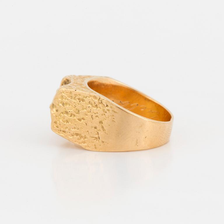 A ring with textured surface.