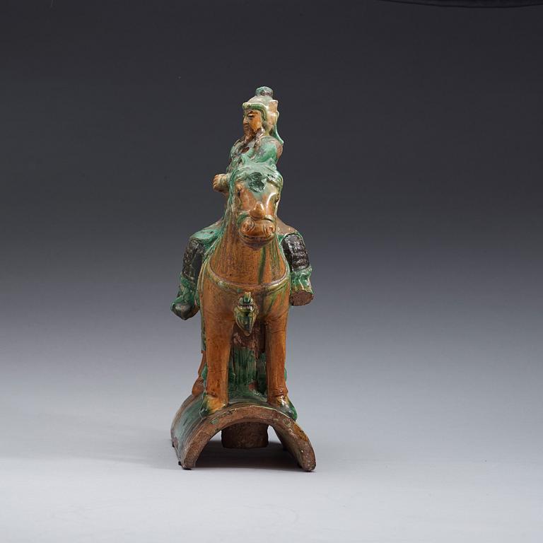 A green and brown glazed ridge tile figure of Guan Yu riding a horse, Ming dynasty  17th century.