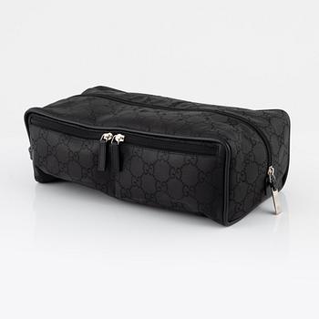 Gucci, a canvas shoe bag.