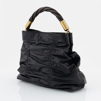 Gucci, a black leather handbag.