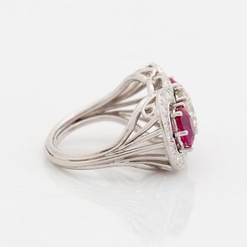 An 18K white gold ring set with faceted rubies and a round brilliant-cut diamond and eight-cut diamonds.