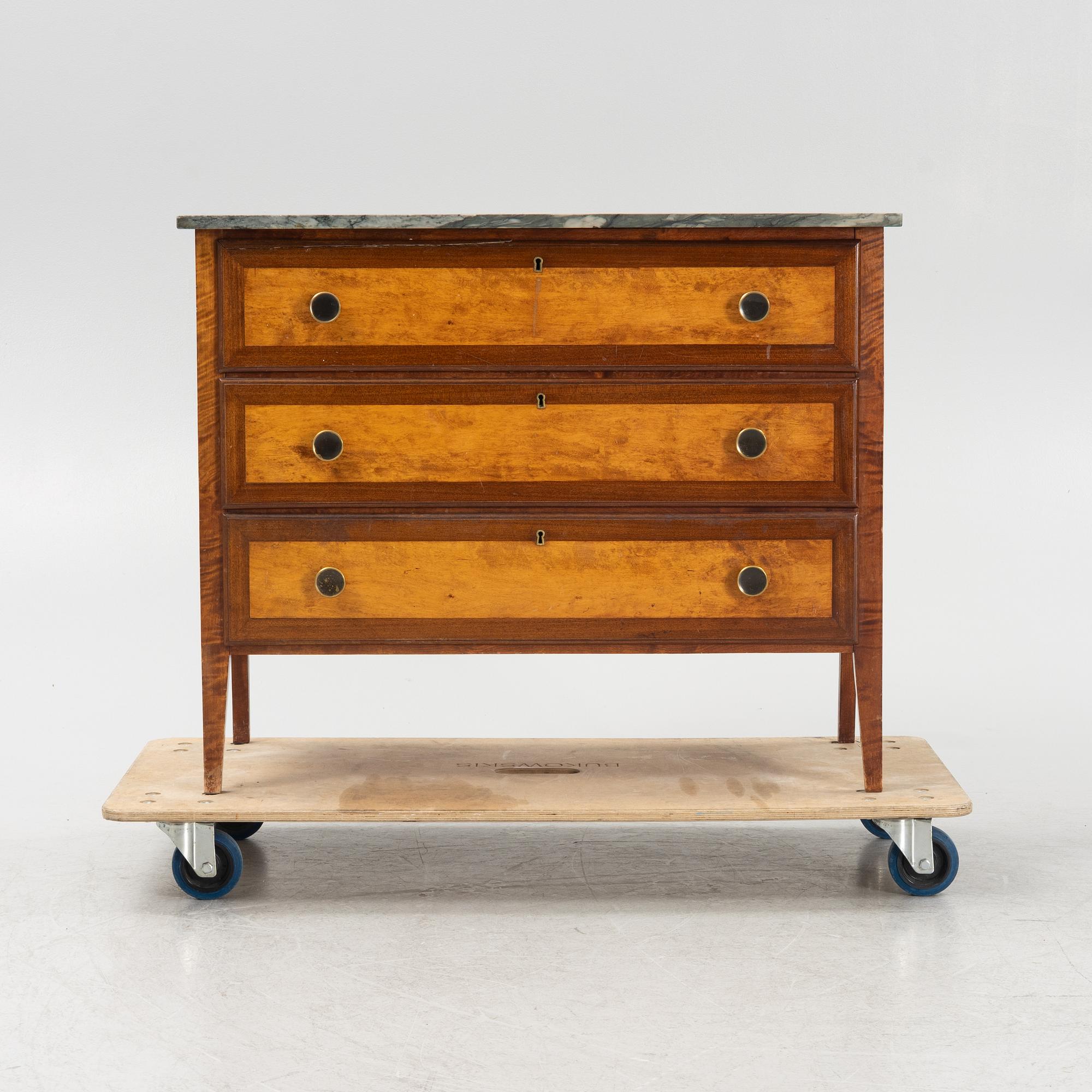A mahogany and birch veneered dresser with a stone top.